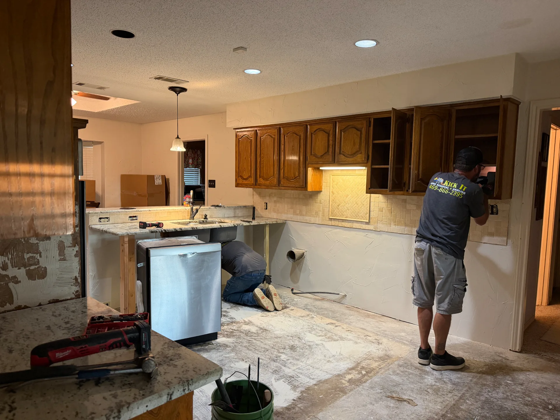 Kitchen before demolition with cabinets and countertops still in place