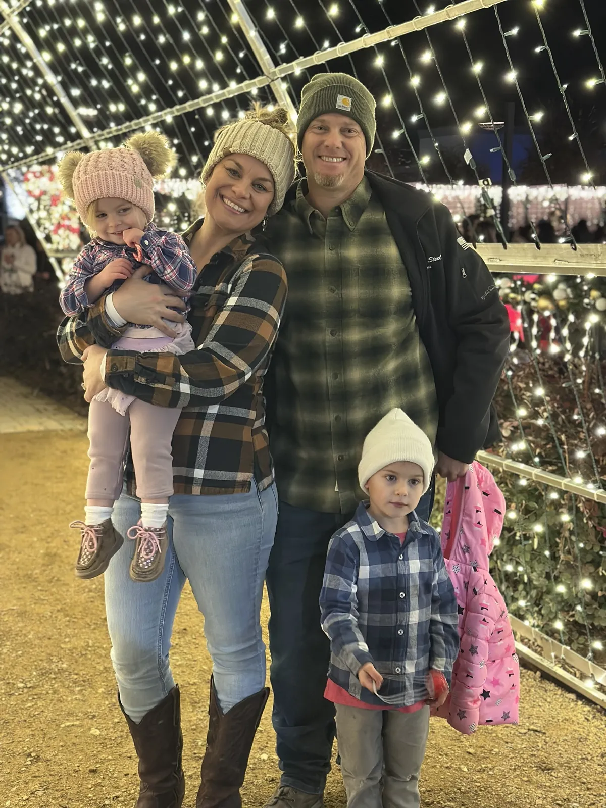 Paul, Jenn and their two kids at a Christmas light display