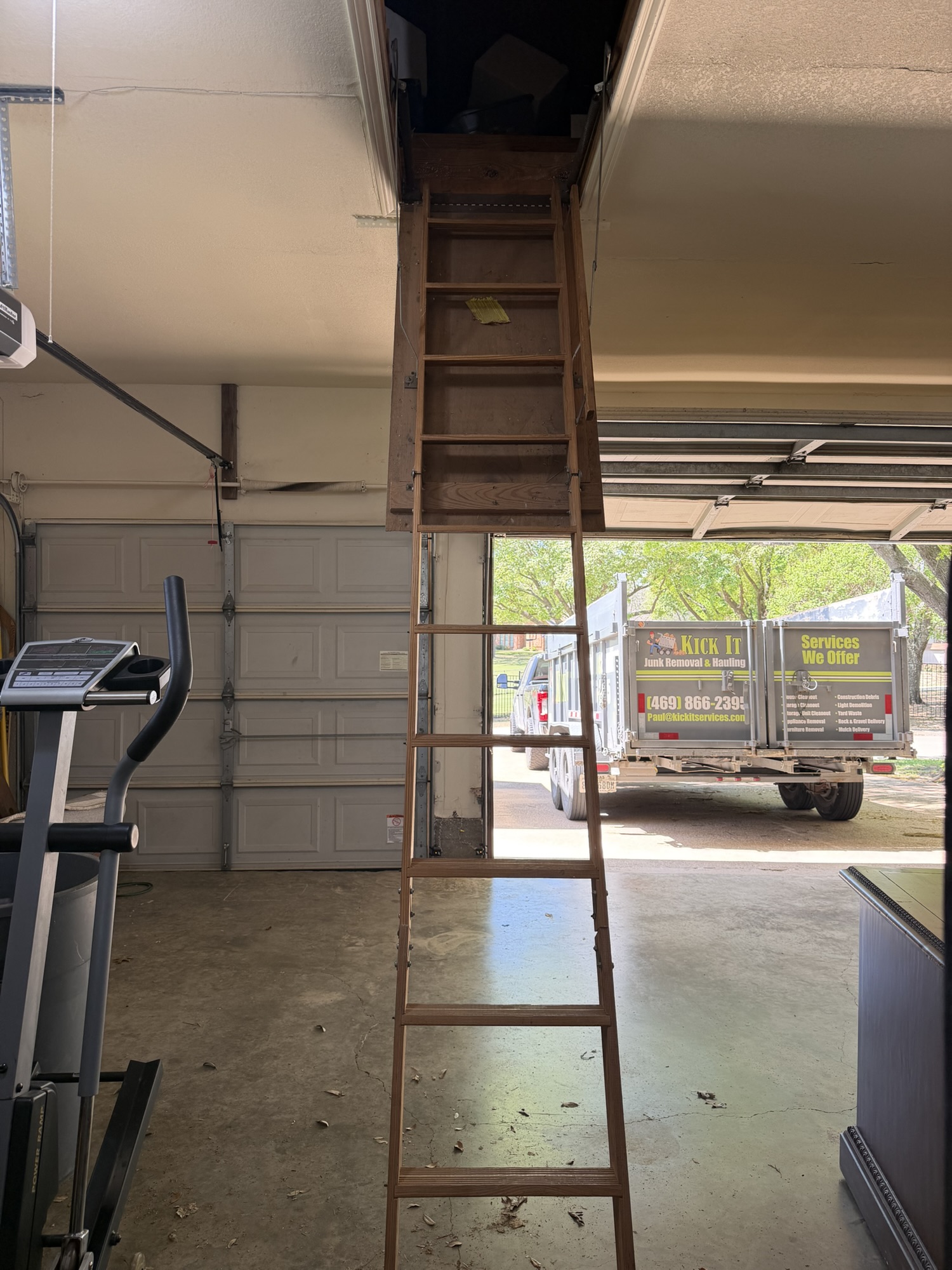 Attic storage filled with boxes and household belongings before removal