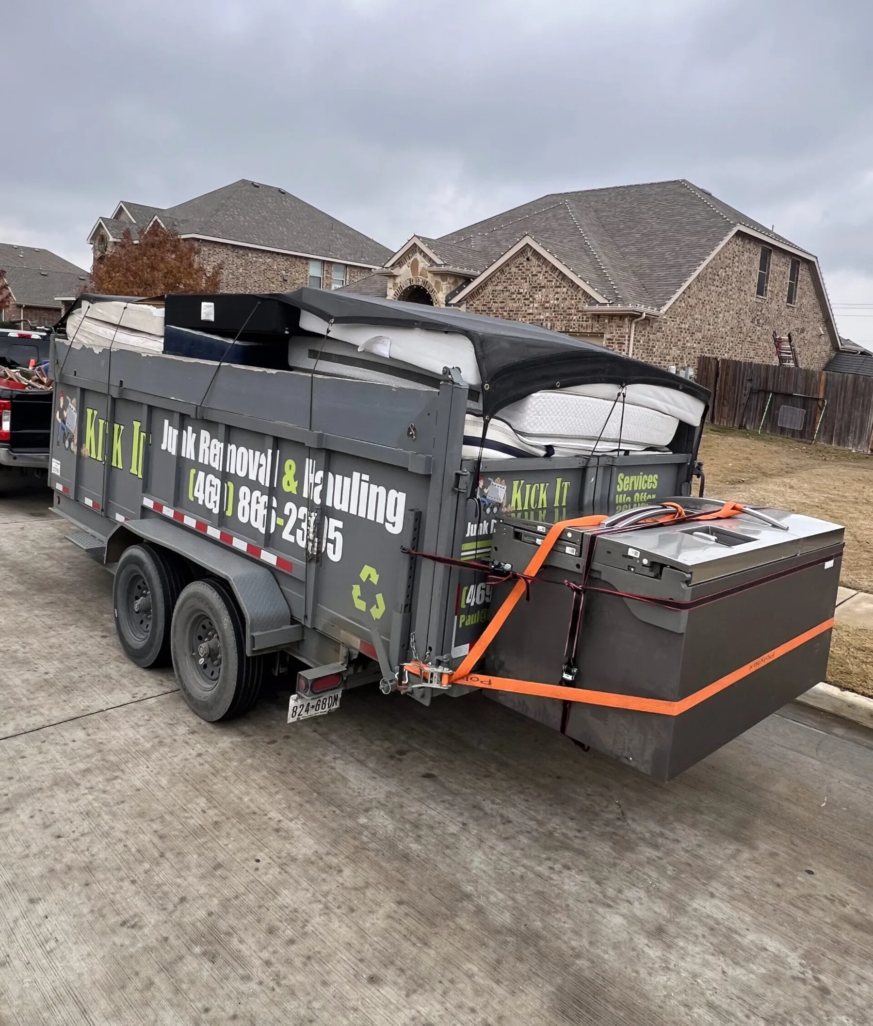 Kick It trailer loaded with furniture and junk from an apartment cleanout