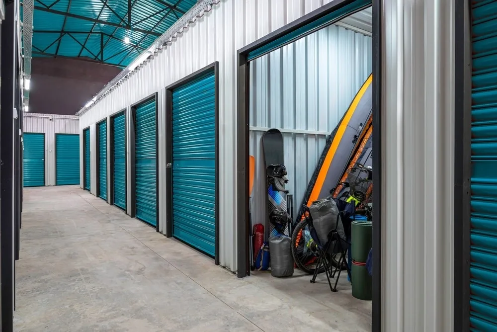 Storage facility hallway with an open unit ready for cleanout in Forney, TX