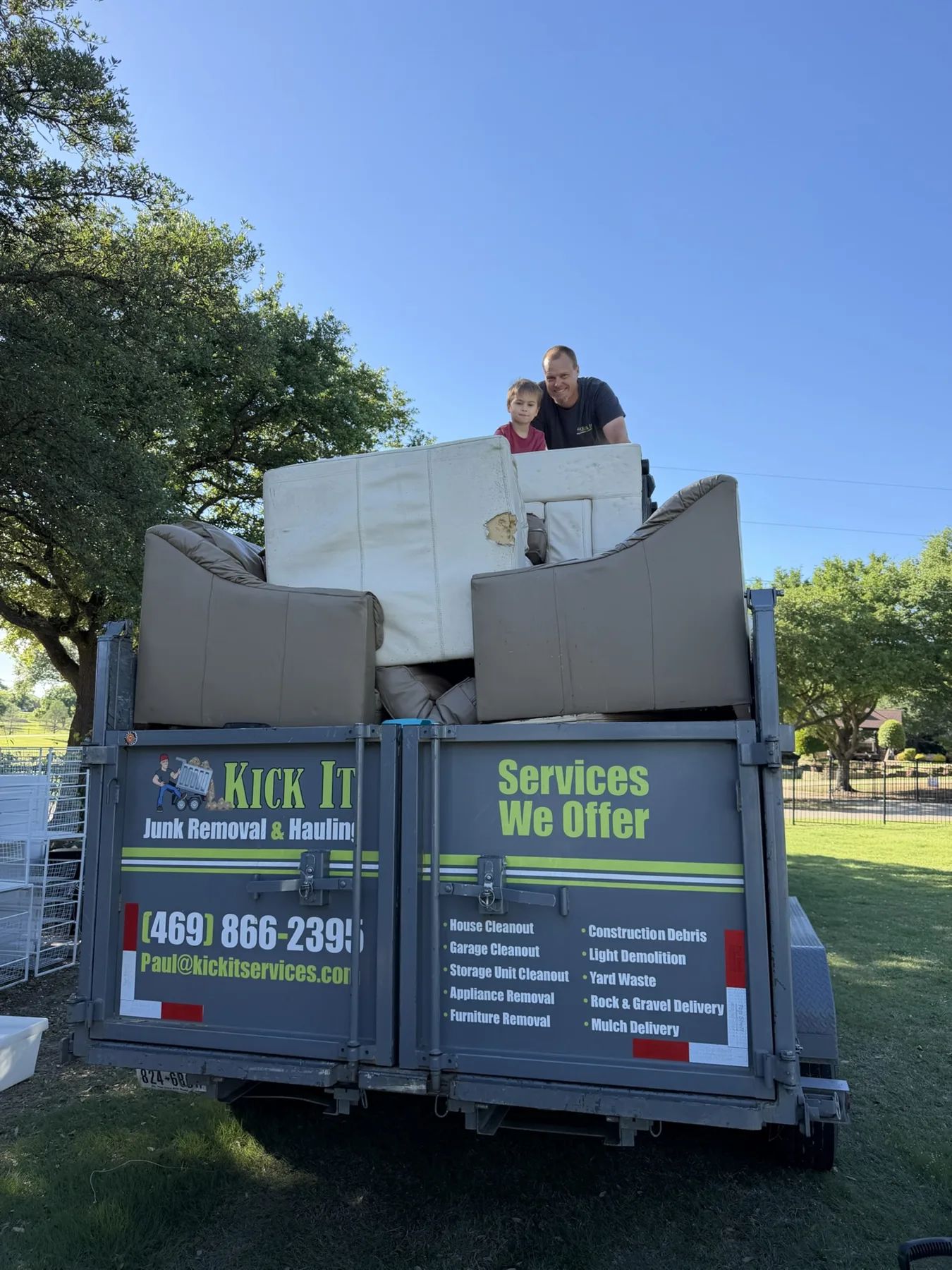 Paul and his son with the Kick It trailer during a cleanout