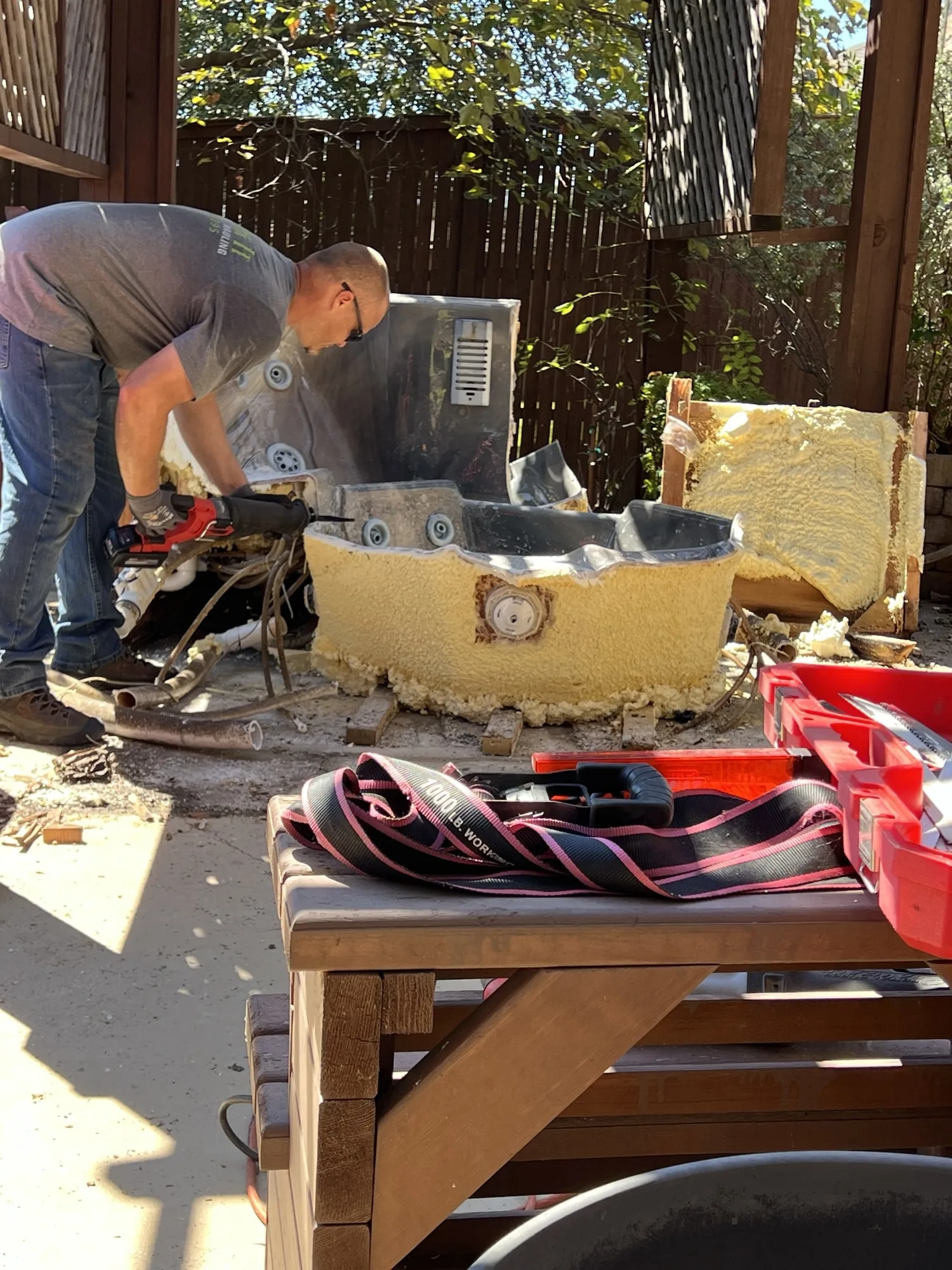 Kick It crew breaking down an old hot tub for removal