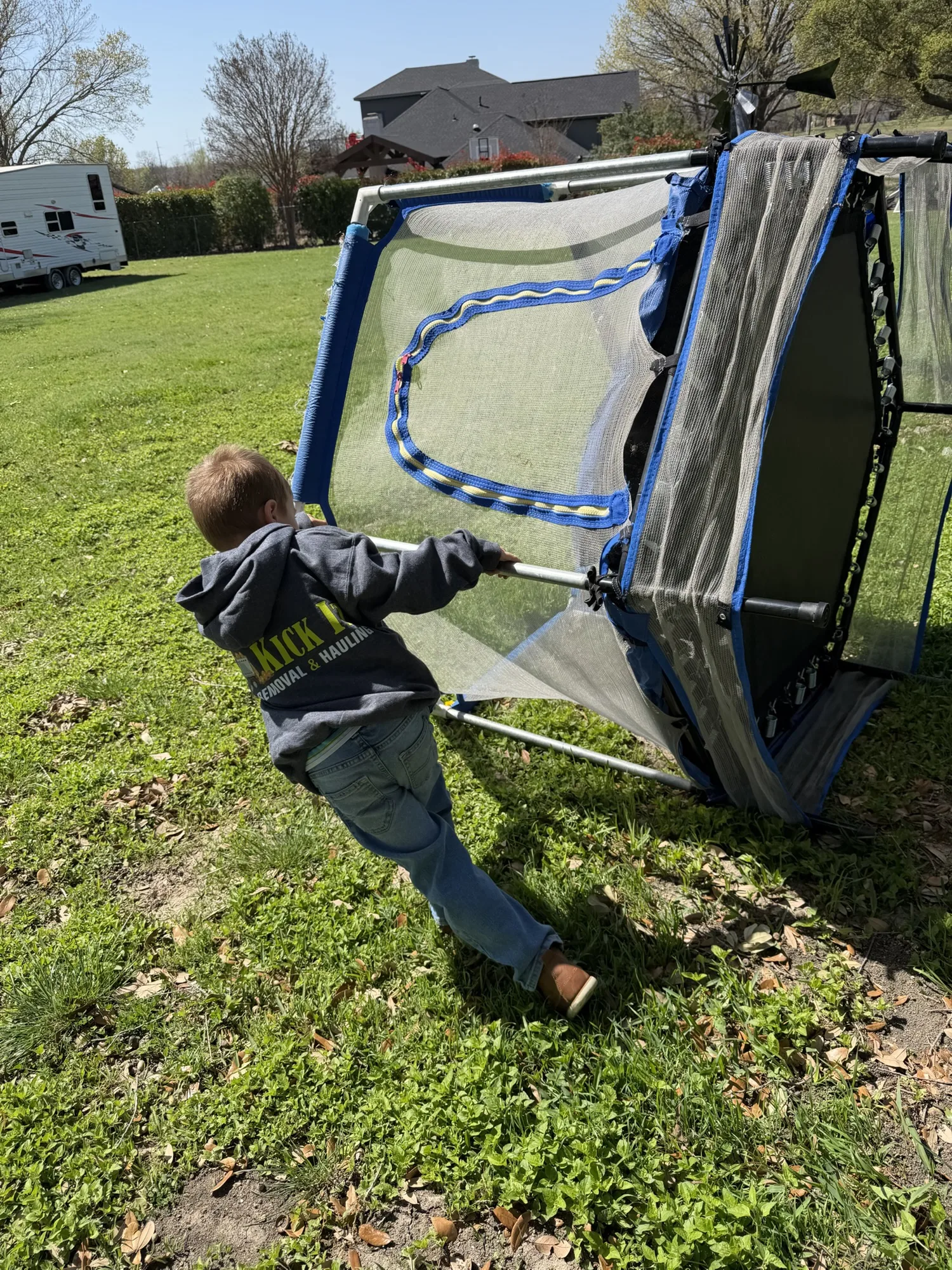 Trampoline being moved during a Kick It trampoline removal