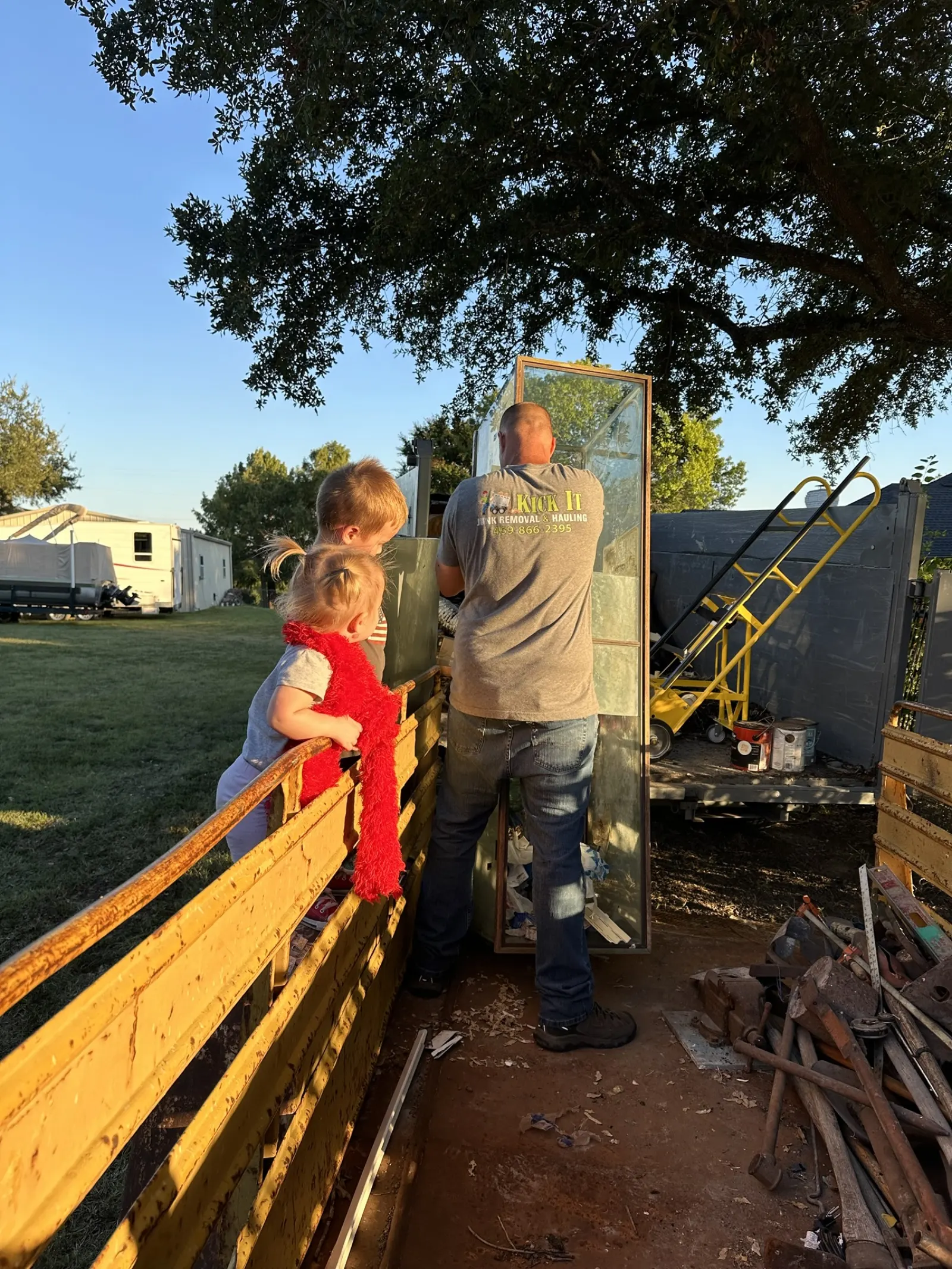 Paul unloading the Kick It trailer with the kids watching