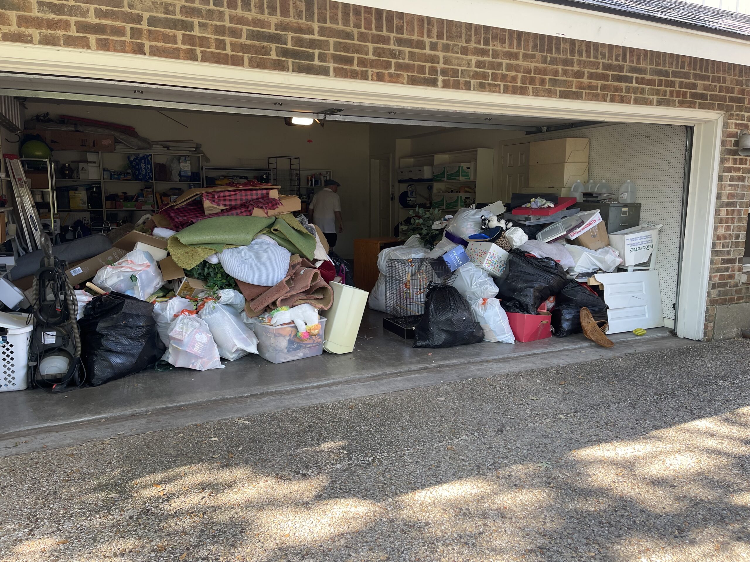 Furniture and household clutter ready for removal from a garage