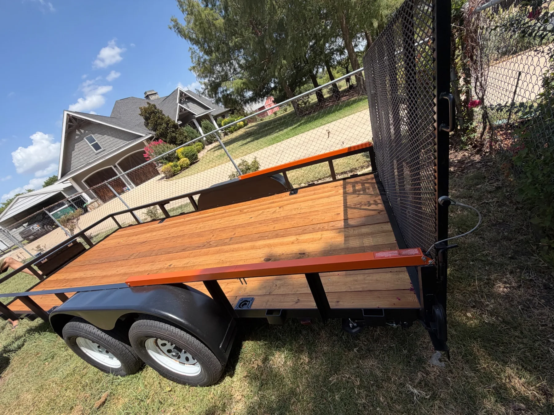 Rebuilt flatbed trailer with new wood tires paint and reinforced sides for Kick It Junk Removal