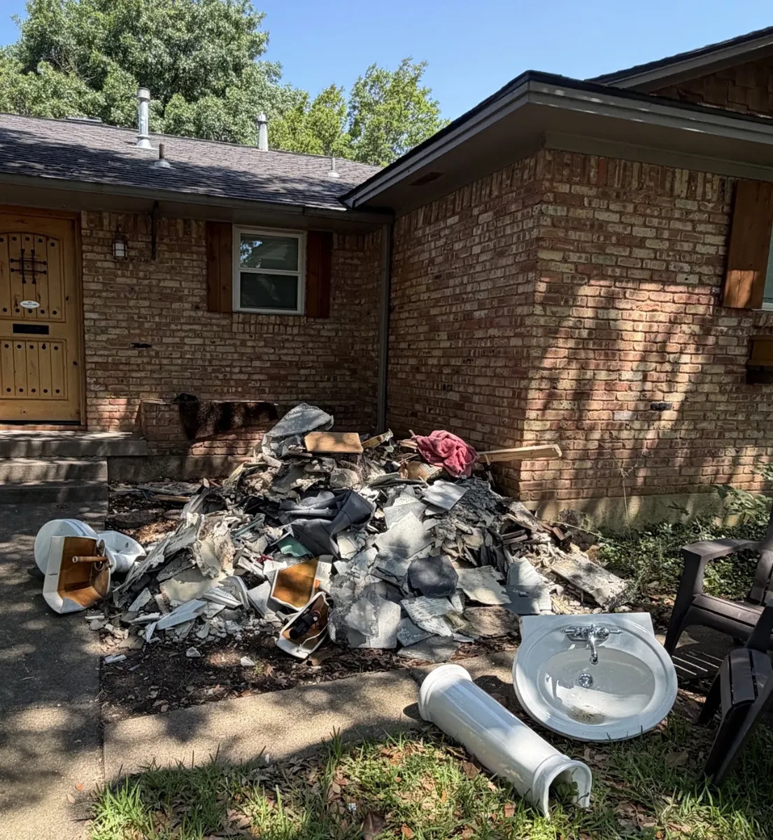 Before photo of bathroom demo debris posted by Laurie Freelove in a Google review of Kick It Junk Removal