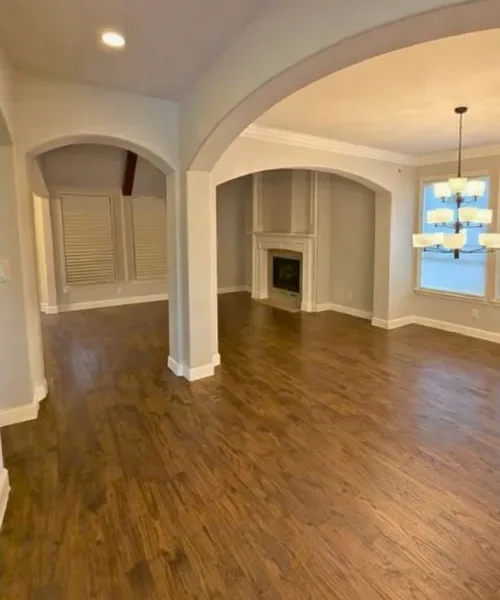 After photo of the same living room cleared out with floors left clean