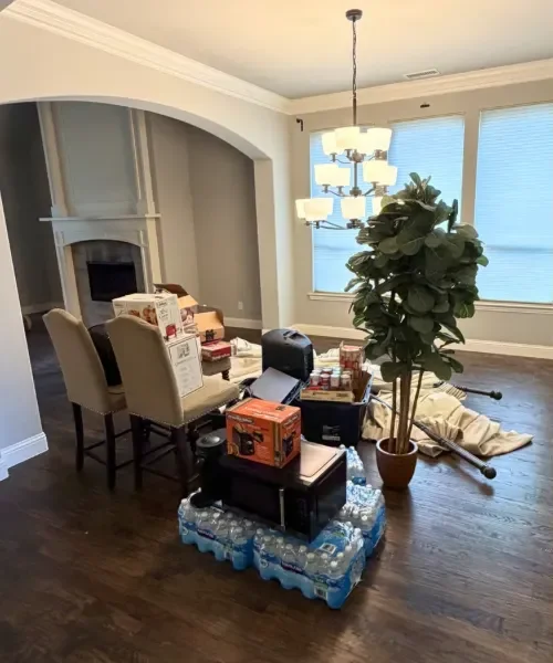 Before photo of a living room with moving boxes and a few household items left behind