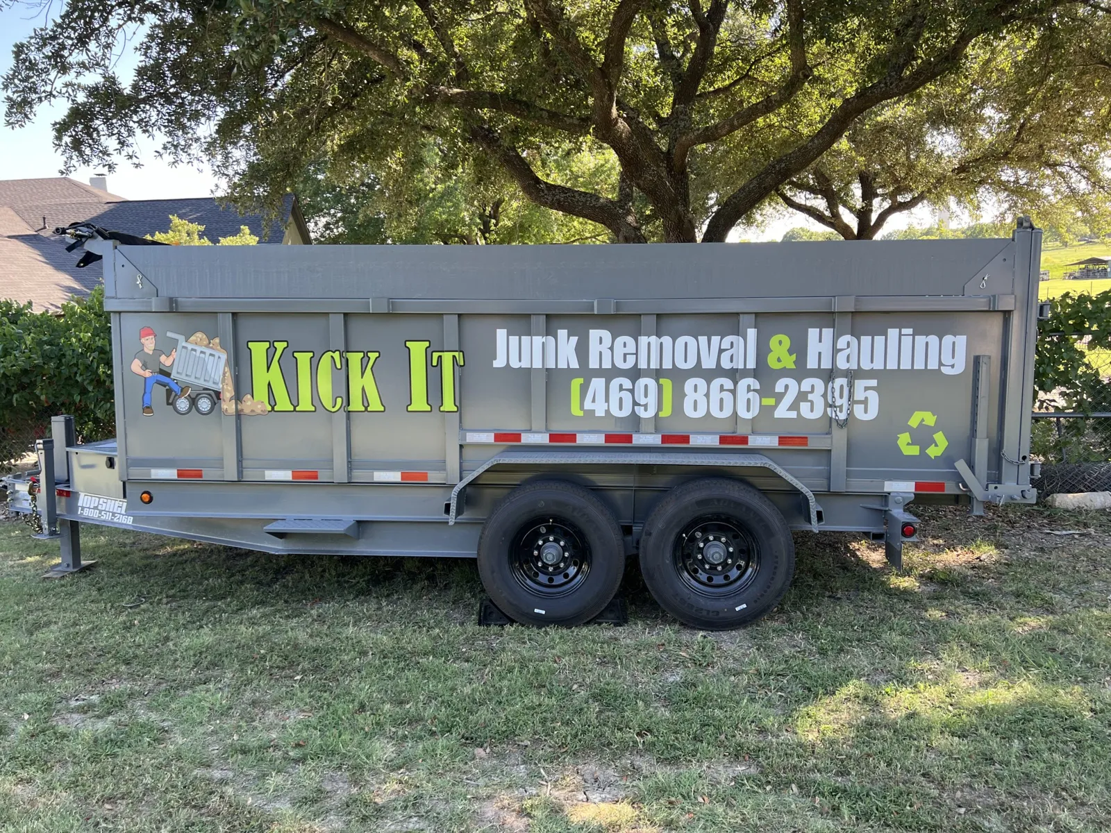 Kick It Junk Removal & Hauling dump trailer parked in a Forney, TX yard