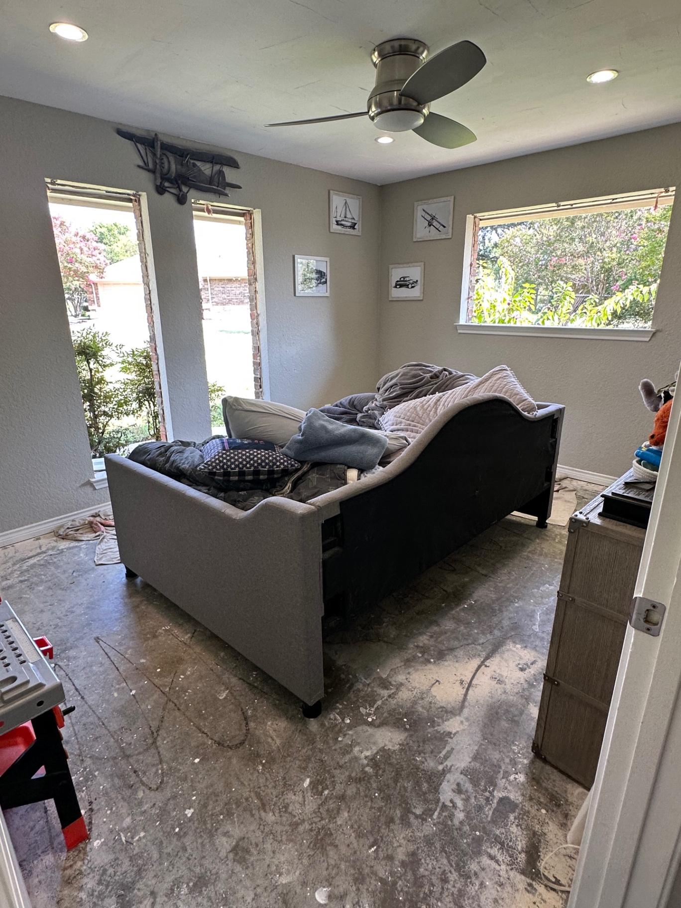 Upholstered gray daybed in a bedroom during a removal job