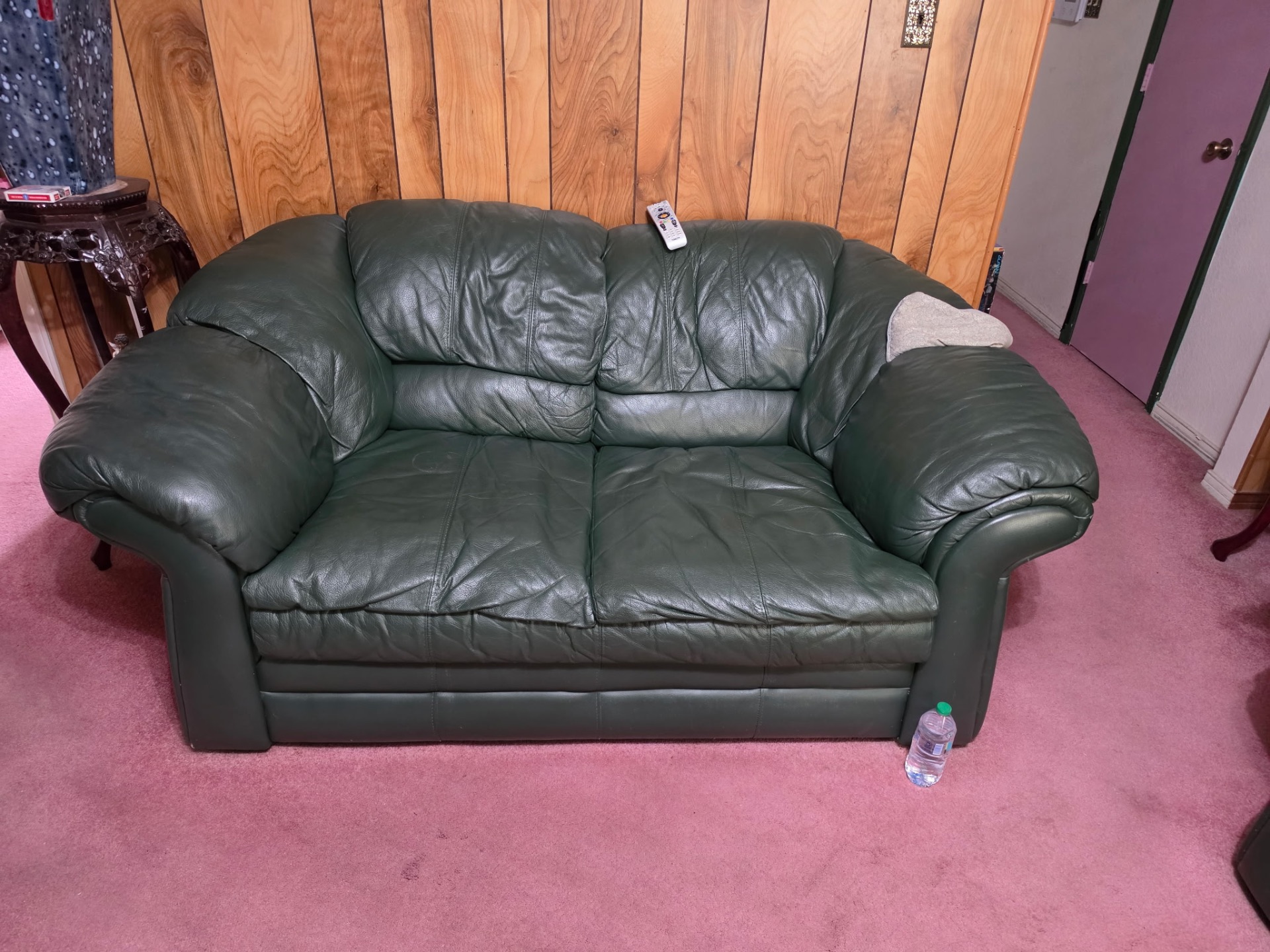 Green leather loveseat ready for pickup