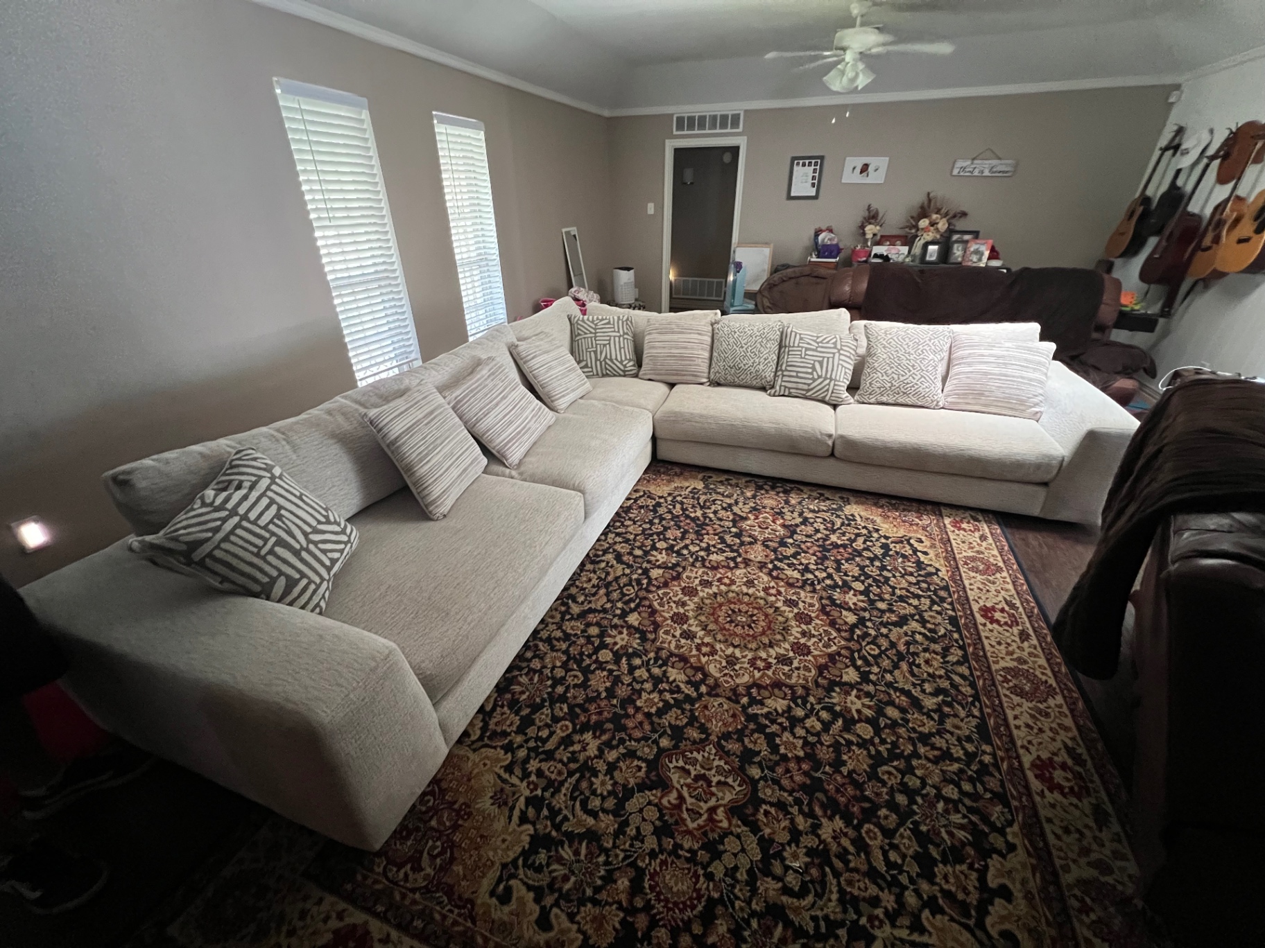 Large cream sectional sofa in a Forney living room before removal
