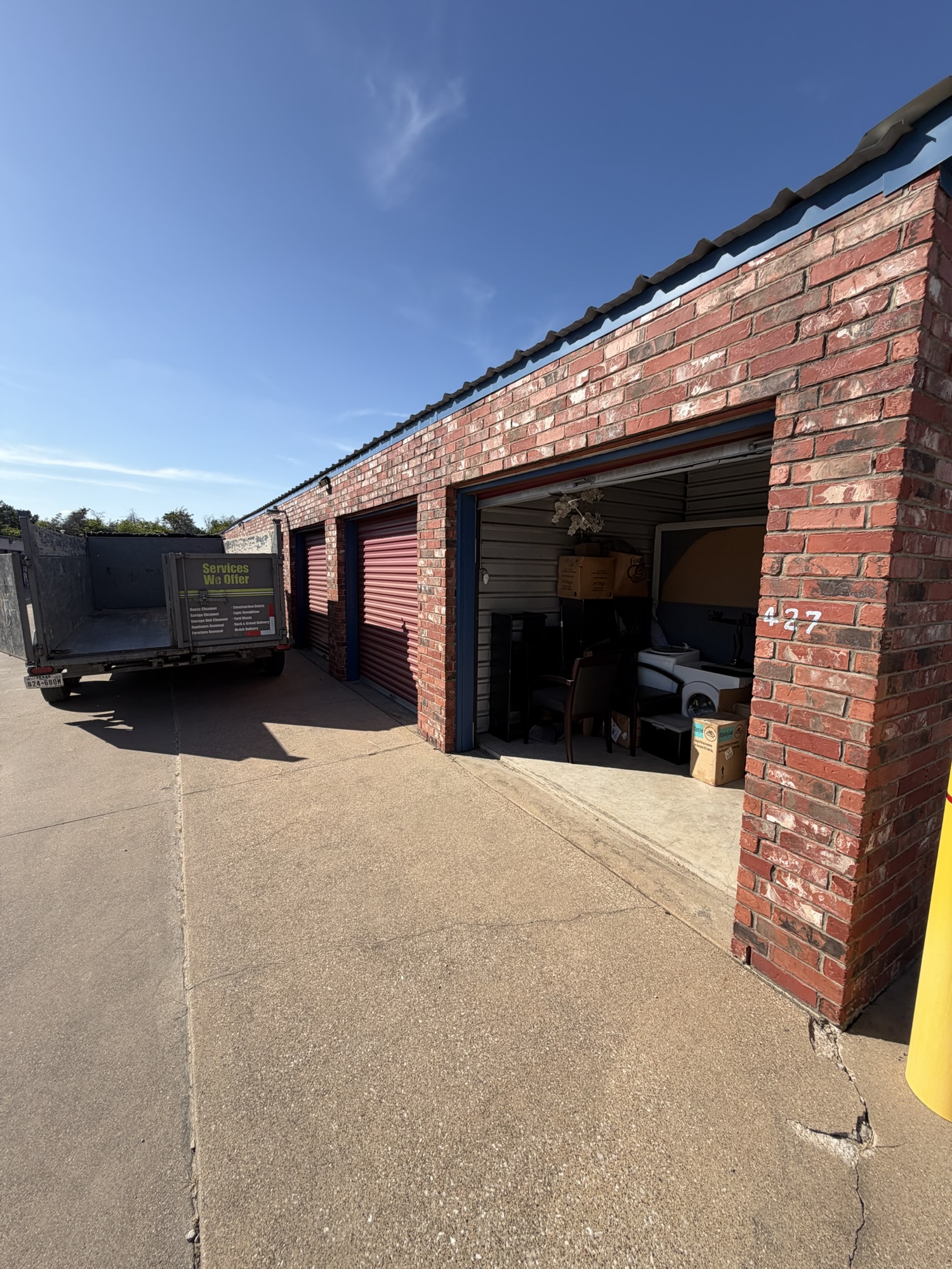 Storage unit full of furniture and boxes before cleanout